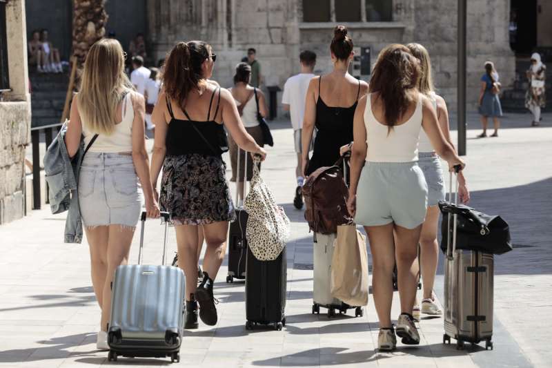 Un grupo de turistas caminan con sus maletas por el centro de ValÃ¨ncia, en una imagen de este mes de septiembre. EFE/Ana Escobar
